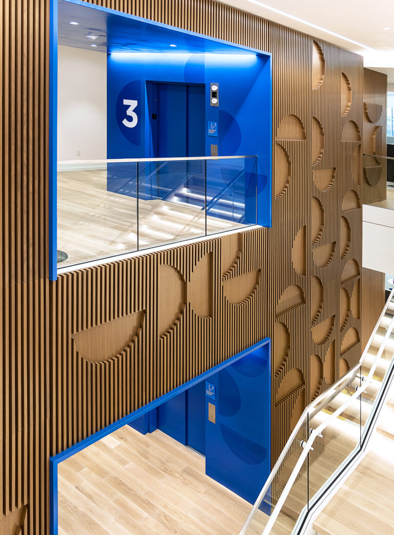 Zoomed out view shows the grand feel of the wood slat pattern that spreads from the 2nd to the 3rd floor of the Scoular office.