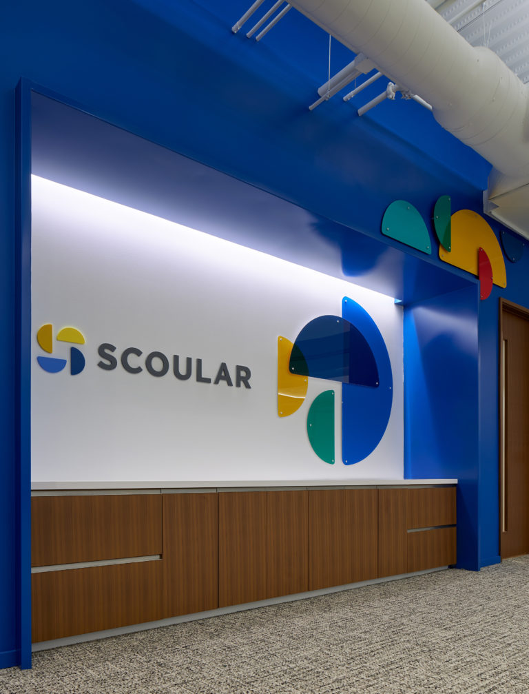 An environmental graphic installation outside the Scoular training room features 3-D elements from the logo.