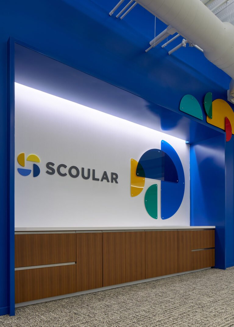 An environmental graphic installation outside the Scoular training room features 3-D elements from the logo.