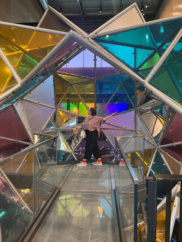 A woman posing in a colorful art installation