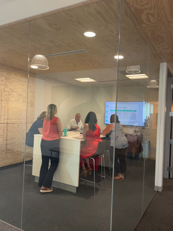 a group of people meeting in a glass office space