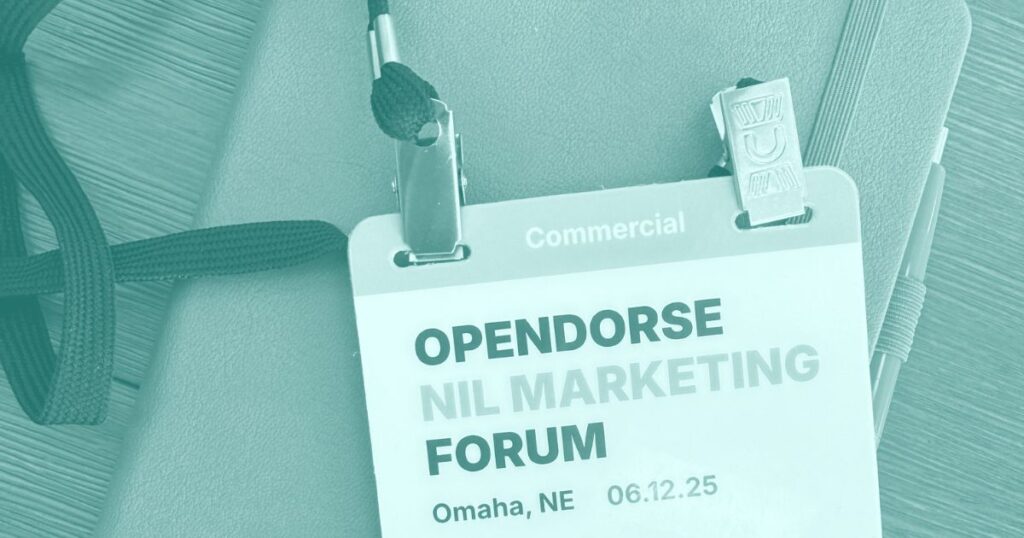 A name tag with the Opensorse NIL Marketing Forum title laying on a notebook.