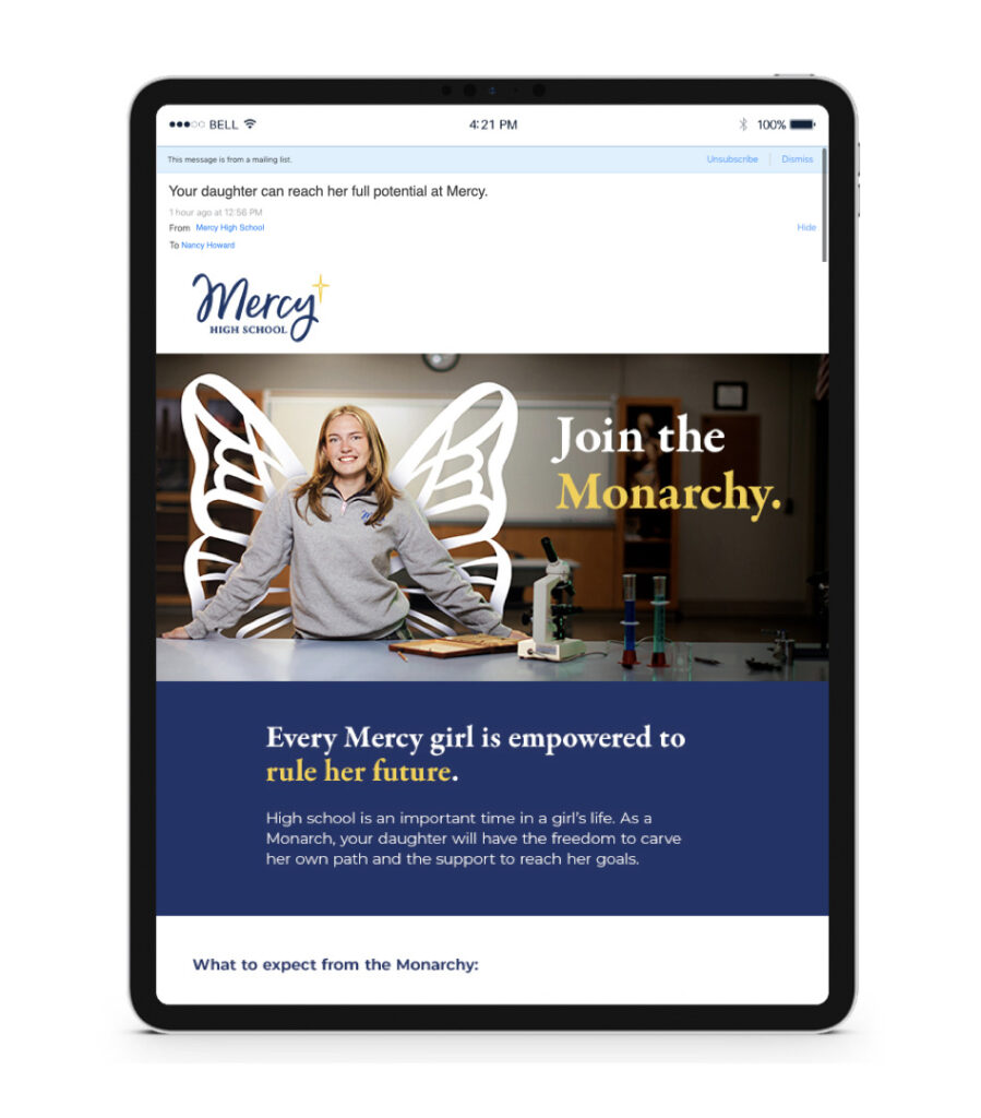 An email layout for Merch High School shown on a tablet. They email layout includes a student in a gray sweatshirt leaning on a desk. The girl has wings, illustrated in white coming from behind her.