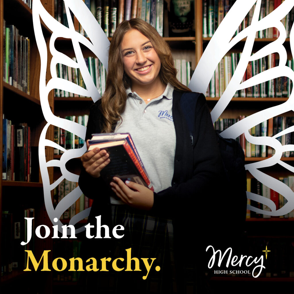 Mercy High School student wearing a school uniform that is a gray collared shirt and a navy cardigan over it. She is carrying two books and has illustrated white wings coming from behind her.