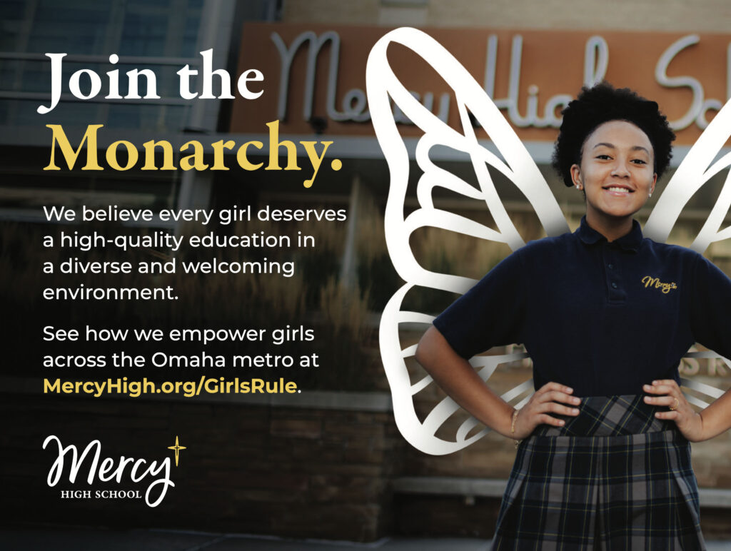 Mercy High School print ad layout. On the left of the layout includes a student with her hands on her hips. She is wearing a navy polo and plaid skirt. There are illustrated white wings coming from behind her. On the right of the layout is the headline Join the Monarchy with supporting copy under it and the Mercy logo.