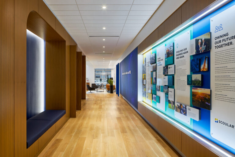 A zoomed out photo shows the detailed story and photography of the Scoular History Wall we wrote and designed.