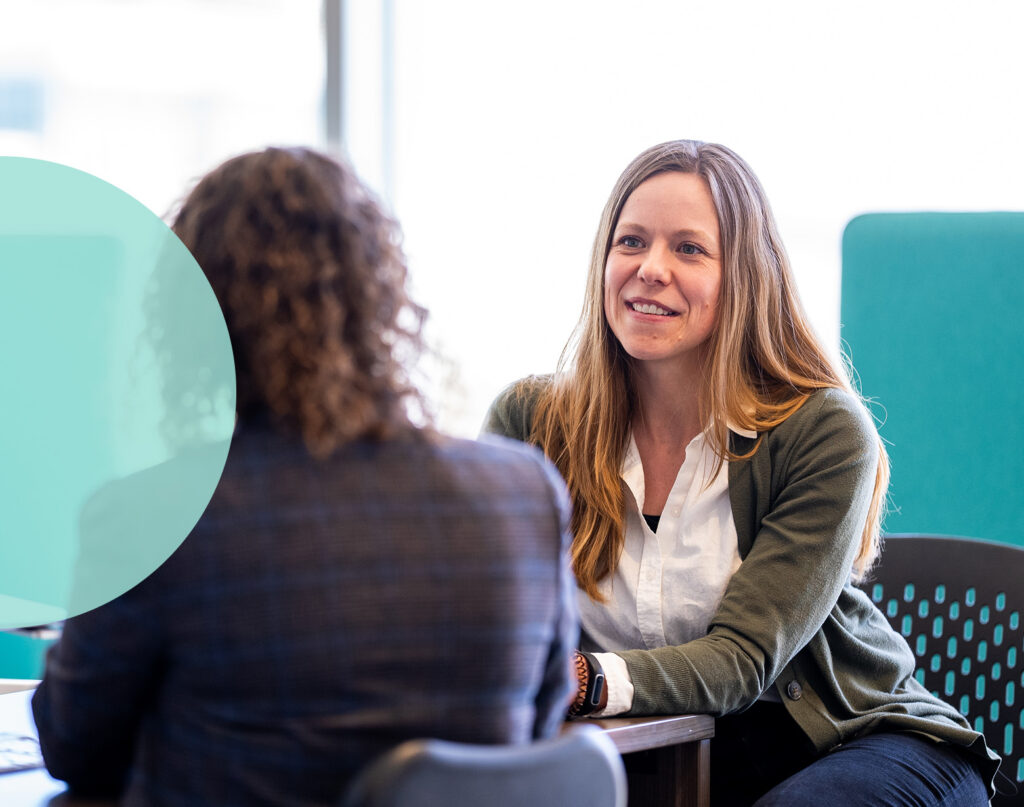 Two Ervin and Smith team members sitting and a table.