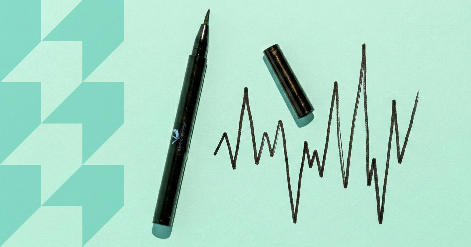 A pen with it's cap off, sits next to a hand-drawn line chart.